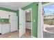 Bright kitchen area leading to laundry and private patio, featuring modern appliances and ample natural light at 7838 Nummie Ct, North Charleston, SC 29418