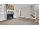 Inviting living room featuring a stone fireplace with built-in shelving and neutral carpet, perfect for cozy gatherings at 7838 Nummie Ct, North Charleston, SC 29418
