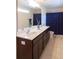 Spacious bathroom with double sinks, dark wood cabinetry, and a large mirror provides a luxurious experience at 7850 Wilderness Trl # 6A, North Charleston, SC 29418