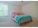 Bright bedroom with a bed and side table illuminated by a lamp near a window at 7850 Wilderness Trl # 6A, North Charleston, SC 29418