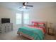 Comfortable bedroom featuring a queen bed, ceiling fan, and dresser with a television at 7850 Wilderness Trl # 6A, North Charleston, SC 29418