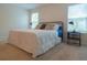 Bright bedroom with a queen bed, neutral carpet, white walls and two large windows at 7850 Wilderness Trl # 6A, North Charleston, SC 29418