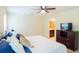 Comfortable bedroom featuring a large bed, ceiling fan, and an entrance to a bathroom at 7850 Wilderness Trl # 6A, North Charleston, SC 29418
