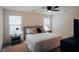 Bright bedroom with a metal bed frame, matching nightstands, and large windows at 7850 Wilderness Trl # 6A, North Charleston, SC 29418
