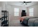 Bedroom with ceiling fan, dresser, TV and view of a spacious room at 7850 Wilderness Trl # 6A, North Charleston, SC 29418