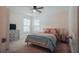 Cozy bedroom features neutral walls, ceiling fan, plush carpet, and natural light from two windows at 7850 Wilderness Trl # 6A, North Charleston, SC 29418