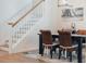 The dining room has a staircase, a dark wood table and four wicker chairs at 7850 Wilderness Trl # 6A, North Charleston, SC 29418