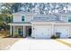 Charming two-story home with a well-maintained lawn, a front porch, and a two-car garage at 7850 Wilderness Trl # 6A, North Charleston, SC 29418