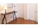 Hallway with a dark wood console table, lamp, and decor underneath a framed artwork piece at 7850 Wilderness Trl # 6A, North Charleston, SC 29418