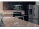Kitchen featuring stainless steel appliances, granite countertops, and dark cabinetry at 7850 Wilderness Trl # 6A, North Charleston, SC 29418