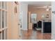 Open-concept living room with wood floors, a ceiling fan, and a glimpse of the backyard at 7850 Wilderness Trl # 6A, North Charleston, SC 29418