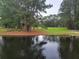 Scenic pond view surrounded by lush trees and green spaces at 7850 Wilderness Trl # 6A, North Charleston, SC 29418