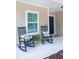 Inviting front porch with rocking chairs and decorative pillows create a welcoming entrance to the home at 7850 Wilderness Trl # 6A, North Charleston, SC 29418