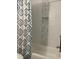 Clean white bathtub with shower and blue patterned shower curtain at 804 Temple Rd # B, Ladson, SC 29456