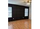 Bedroom featuring a black paneled wall, laminate flooring, and a modern ceiling fan at 804 Temple Rd # B, Ladson, SC 29456