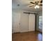 Hallway with barn door, access to the exterior, and laminate flooring at 804 Temple Rd # B, Ladson, SC 29456