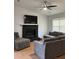 Inviting living room featuring a brick fireplace, modern ceiling fan, and comfortable gray couches at 804 Temple Rd # B, Ladson, SC 29456