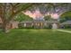 Charming brick home with a lush green lawn and mature tree in a peaceful neighborhood setting at 816 Farnham Rd, Charleston, SC 29412