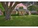 Charming brick home with lush green lawn, attached garage and mature trees in a neighborhood setting at 816 Farnham Rd, Charleston, SC 29412