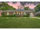 Charming brick home features a well-maintained lawn, attached garage, and a welcoming front porch at 816 Farnham Rd, Charleston, SC 29412
