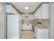 Bright kitchen with white cabinetry, appliances and floral wallpaper at 816 Farnham Rd, Charleston, SC 29412