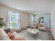 Airy living room featuring natural light, hardwood floors, contemporary decor and a soft color palette at 816 Farnham Rd, Charleston, SC 29412