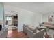 Spacious living room with hardwood floors leading to an adjacent room with a brick fireplace feature at 816 Farnham Rd, Charleston, SC 29412