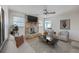Bright living room featuring a brick fireplace, a ceiling fan and a white couch set for relaxation at 816 Farnham Rd, Charleston, SC 29412