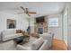 Bright living room featuring a brick fireplace, a ceiling fan and a white couch set for relaxation at 816 Farnham Rd, Charleston, SC 29412