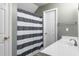 Bathroom featuring a white sink and vanity, and a blue and white striped shower curtain at 8651 Grassy Oaks Trl, North Charleston, SC 29420