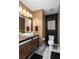 Stylish powder room with modern vanity, statement mirror, and elegant lighting at 8651 Grassy Oaks Trl, North Charleston, SC 29420