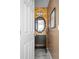 Stylish powder room features granite counters and a designer mirror and lighting at 8651 Grassy Oaks Trl, North Charleston, SC 29420