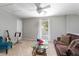 Spacious bonus room with comfortable seating, ceiling fan, and natural light at 8651 Grassy Oaks Trl, North Charleston, SC 29420