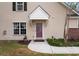 Inviting home entrance featuring a covered front door, neutral siding, and charming landscaping at 8651 Grassy Oaks Trl, North Charleston, SC 29420
