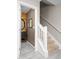 Hallway with view of powder room on left and carpeted stairs and railing on right at 8651 Grassy Oaks Trl, North Charleston, SC 29420