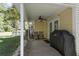 Covered patio featuring a ceiling fan, seating, and an outdoor grill at 8651 Grassy Oaks Trl, North Charleston, SC 29420