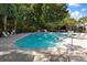 Community pool surrounded by lounge chairs at 8651 Grassy Oaks Trl, North Charleston, SC 29420