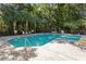 Community pool featuring lounge chairs and mature trees in the background at 8651 Grassy Oaks Trl, North Charleston, SC 29420