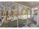 Private backyard featuring a screen porch, white picket fence, and mature landscaping at 8653 Grassy Oak Trl, North Charleston, SC 29420
