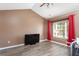 Spacious bedroom with durable flooring, a large window with curtains, and a ceiling fan at 8653 Grassy Oak Trl, North Charleston, SC 29420