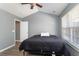 Bright bedroom featuring vaulted ceilings, a ceiling fan, and a door leading to the bathroom at 8653 Grassy Oak Trl, North Charleston, SC 29420