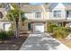 Charming townhome featuring a one car garage, a blue front door and mature trees at 8653 Grassy Oak Trl, North Charleston, SC 29420