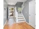 Inviting foyer with tile flooring, stairway, and a view of the outdoors, creating a warm welcome at 8653 Grassy Oak Trl, North Charleston, SC 29420