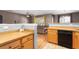 Open concept kitchen and living space featuring wood cabinets and tile floors at 8653 Grassy Oak Trl, North Charleston, SC 29420