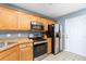Modern kitchen with stainless appliances, wood cabinets, and tile flooring at 8653 Grassy Oak Trl, North Charleston, SC 29420
