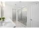 Modern bathroom featuring a glass shower, white marble tile, and a double sink vanity at 8654 Windsor Hill Blvd, North Charleston, SC 29420