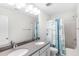 Bright bathroom featuring a double vanity with quartz countertop and shower with decorative curtain at 8654 Windsor Hill Blvd, North Charleston, SC 29420