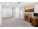 Spacious room with TV, desk, and multiple entry doors at 8654 Windsor Hill Blvd, North Charleston, SC 29420