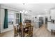 Open dining area with a view into the living room and modern kitchen at 8654 Windsor Hill Blvd, North Charleston, SC 29420