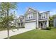 Charming two-story home with a well-manicured lawn and a two-car garage with gray wood-look siding at 8654 Windsor Hill Blvd, North Charleston, SC 29420